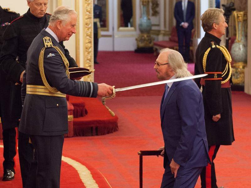 Bee Gees star Sir Barry Gibb has been awarded a knighthood by Prince Charles at Buckingham Palace.